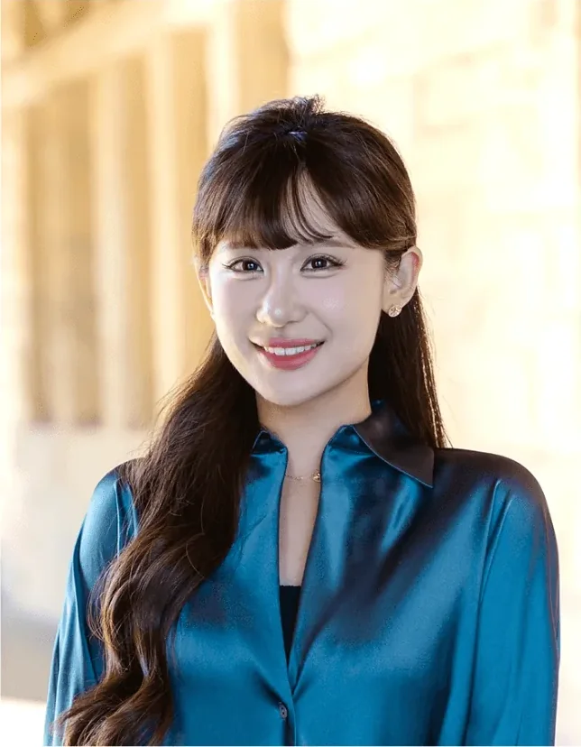 Mia Tang，Young Guns Studio 2018 届学员，身穿蓝色上衣在 Stanford 校园里微笑