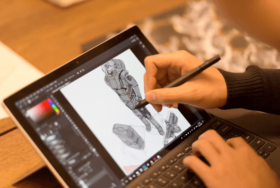 Student sketching a character design on a tablet with a stylus